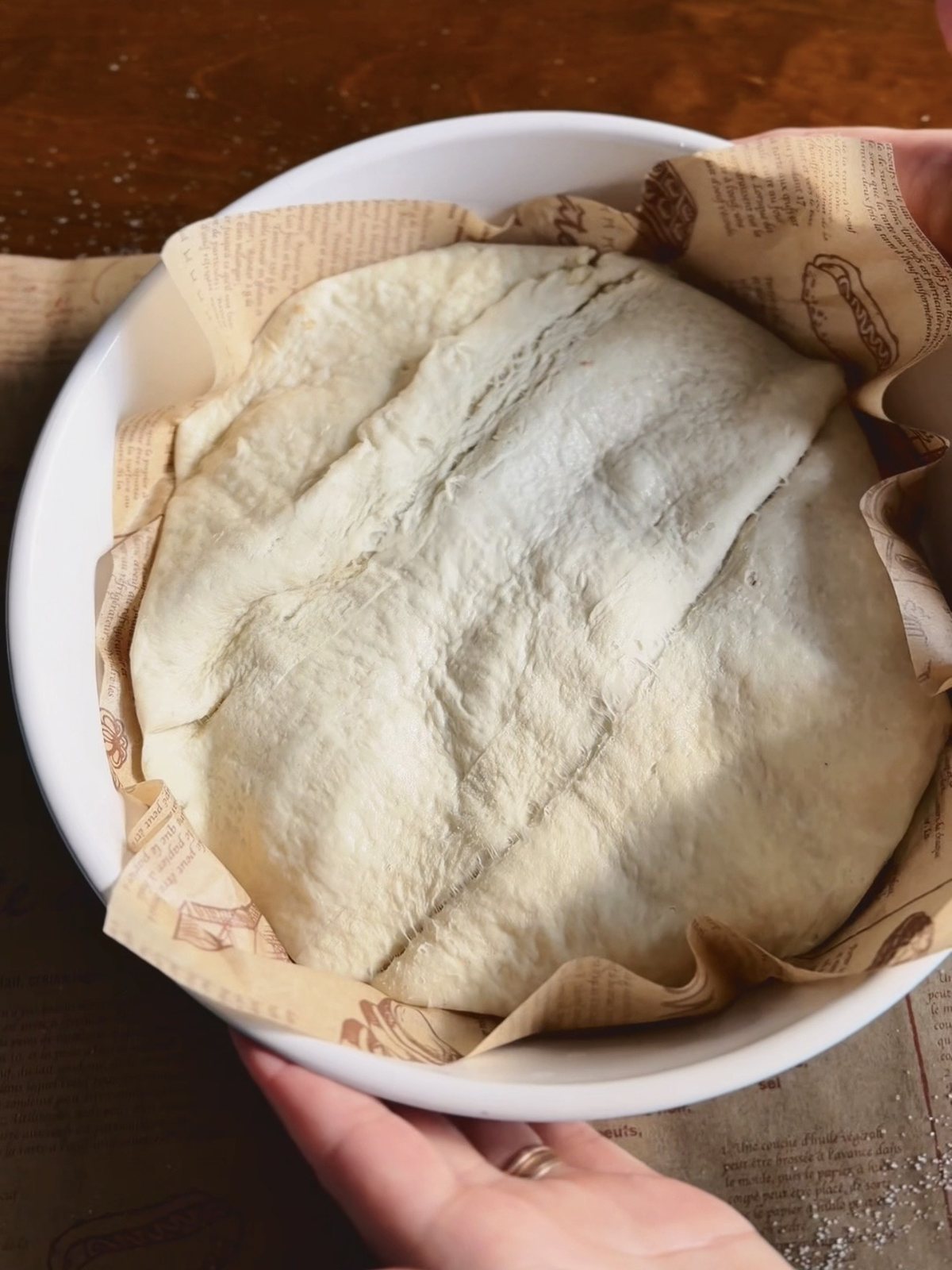 The upside down tart tucked into a round white baking dish and ready for the oven