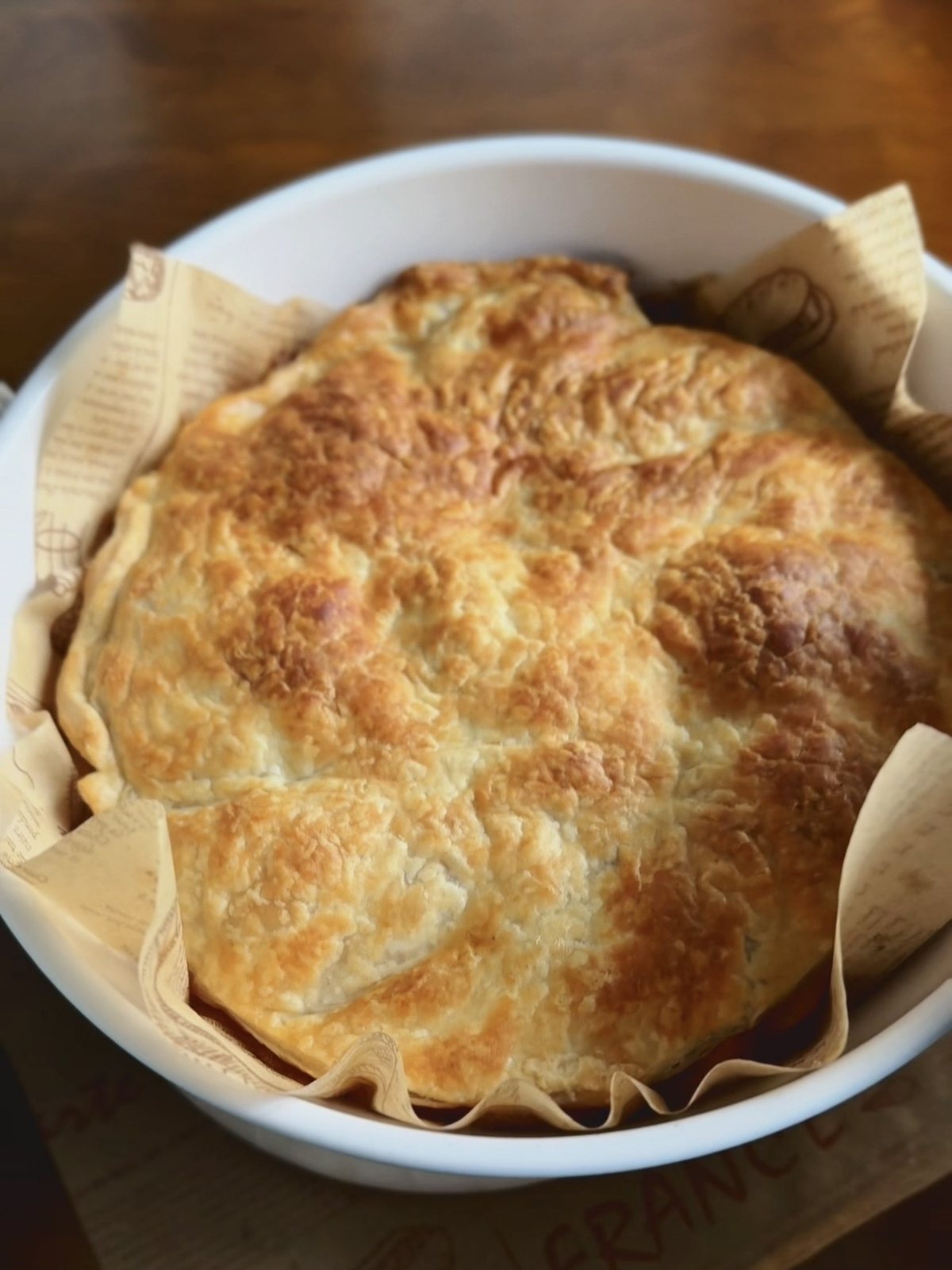 Golden baked puff pastry tart fresh out of the oven in a white baking dish