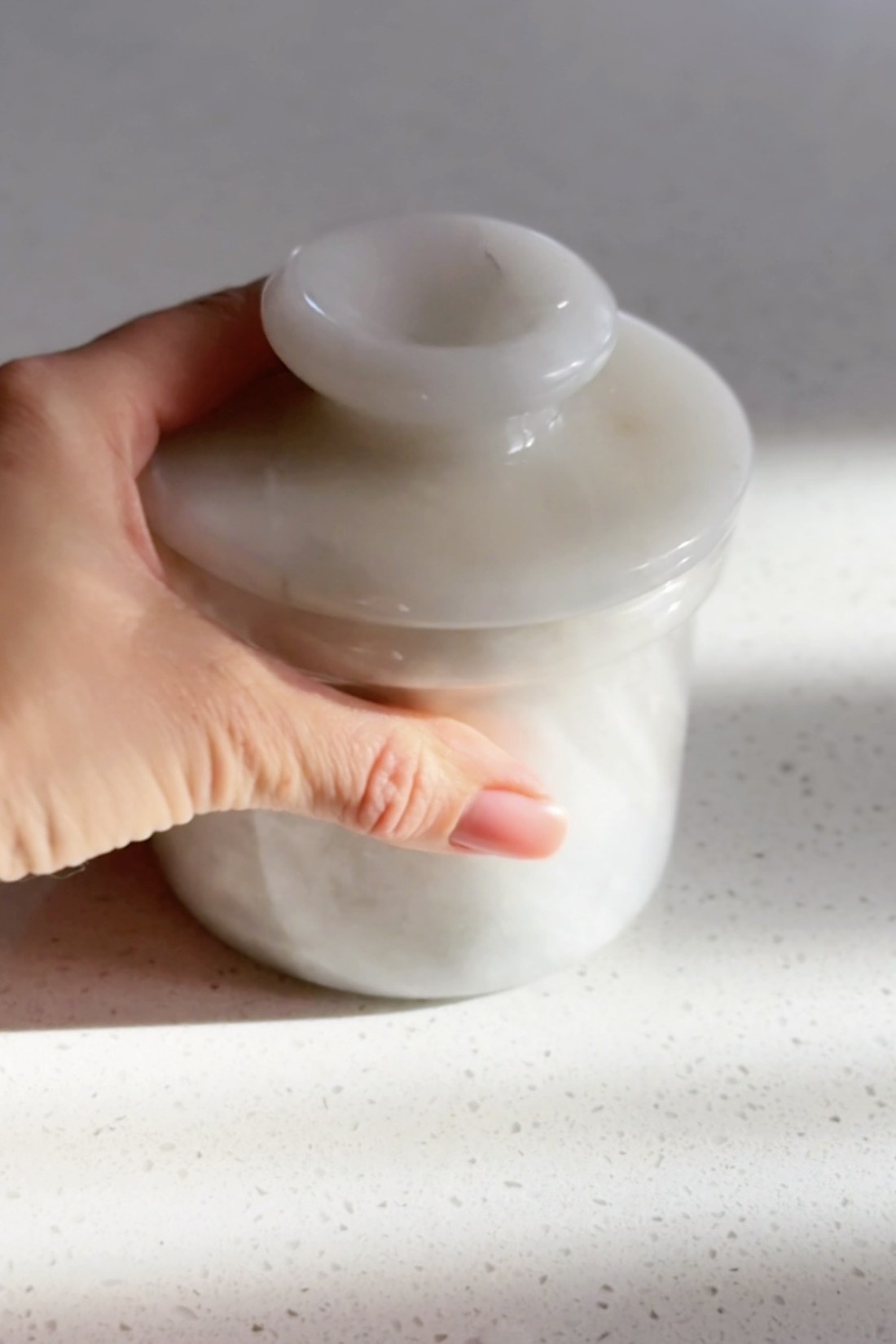 Small white marble French butter keeper with the lid lifted