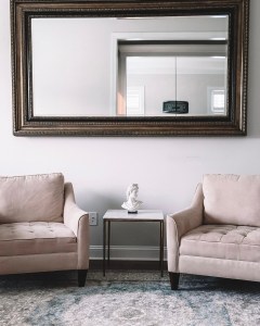 Office with the wide mirror, two chairs and the marble side table