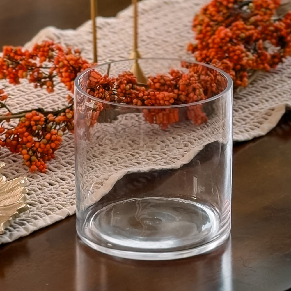 Glass cylinder vase on a fall table runner