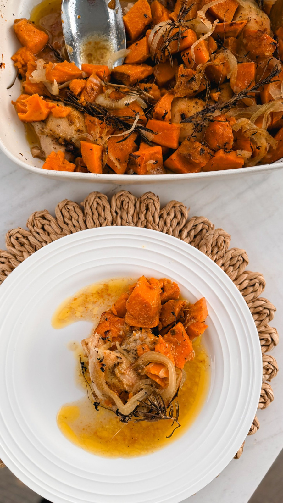 A served plate of one pan chicken and sweet potatoes with the baking dish behind it on a woven placemat